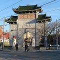 Toronto Chinese Archway -- Diagaonally from Hubbard Park, the gate to East Chinatown is framed by lamp posts and overhead electrical wires.  Landmark unveiled in 2009 is on the northwest side of the district, so I don't normally see it when I come shopping in the area.  Bright clear winter day correlates with cold temperature, Riverdale Library was open for service.  (Toronto Chinese Archway, Hamilton Street, Toronto, Ontario) 20220108